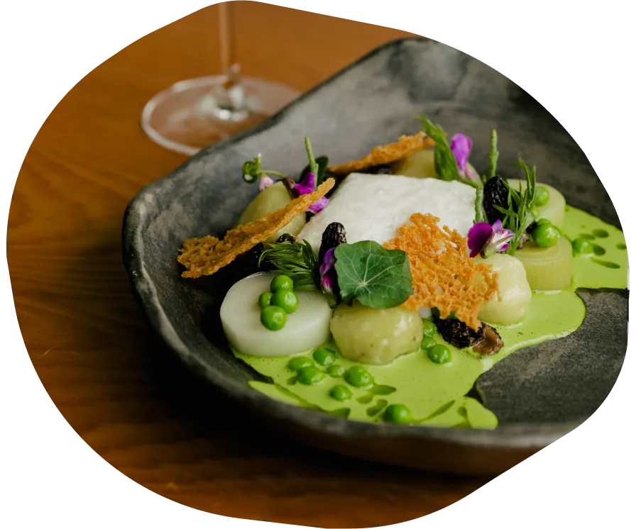 Mix of seafood prepared in  stone dish on a wooden table.